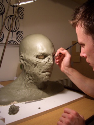 Luke McNally scuplting an Orc head